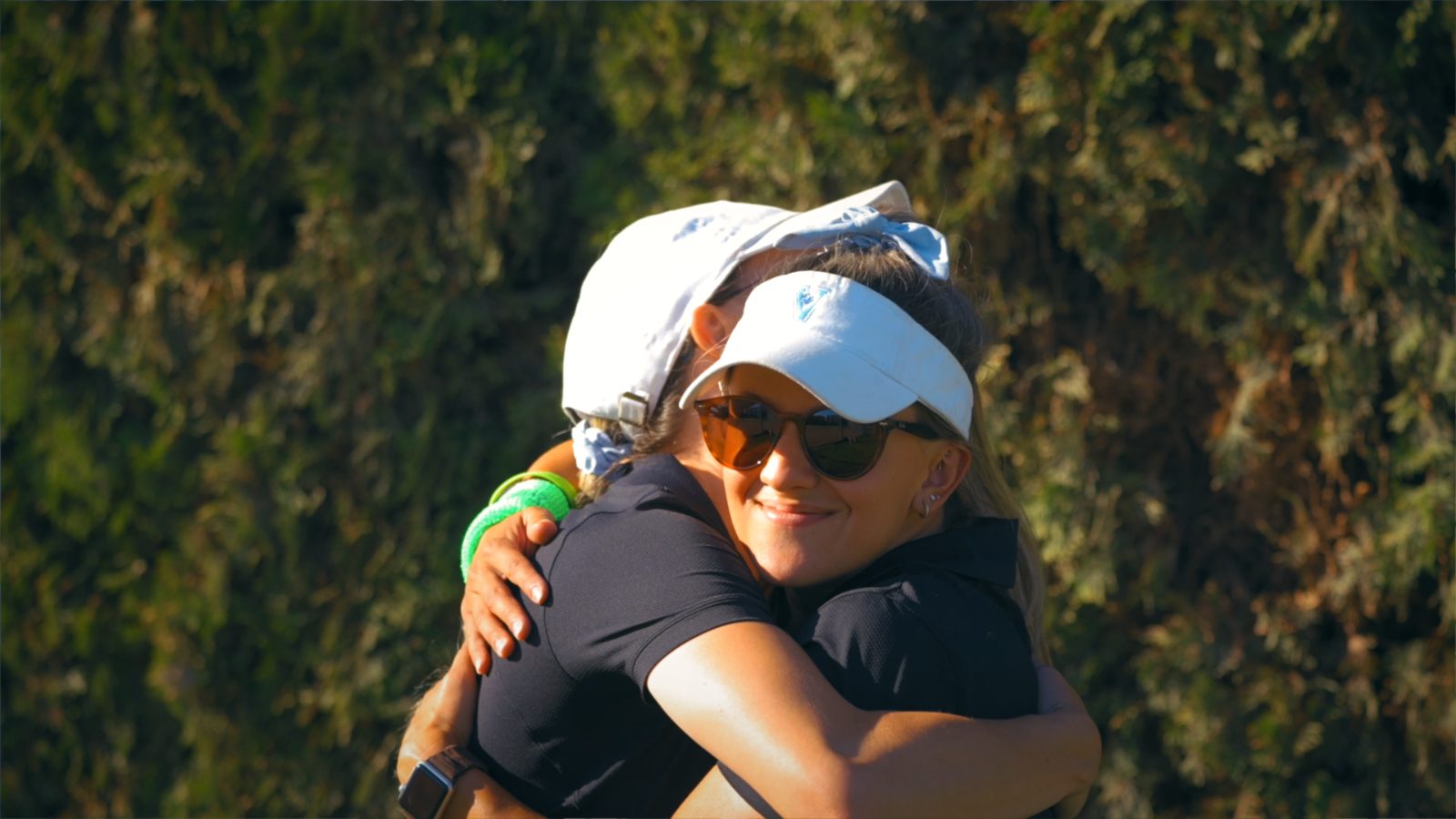 Two athletes embracing after a game